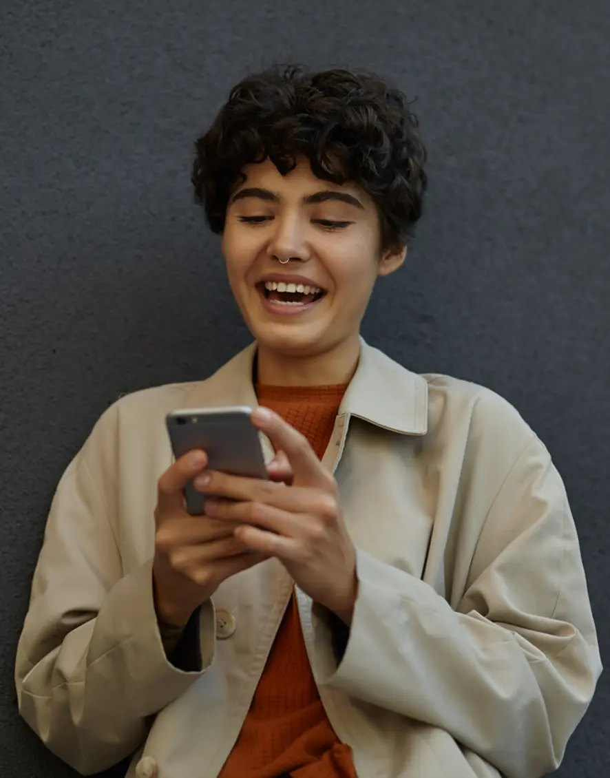 Smiling woman using the neobank app on her phone.