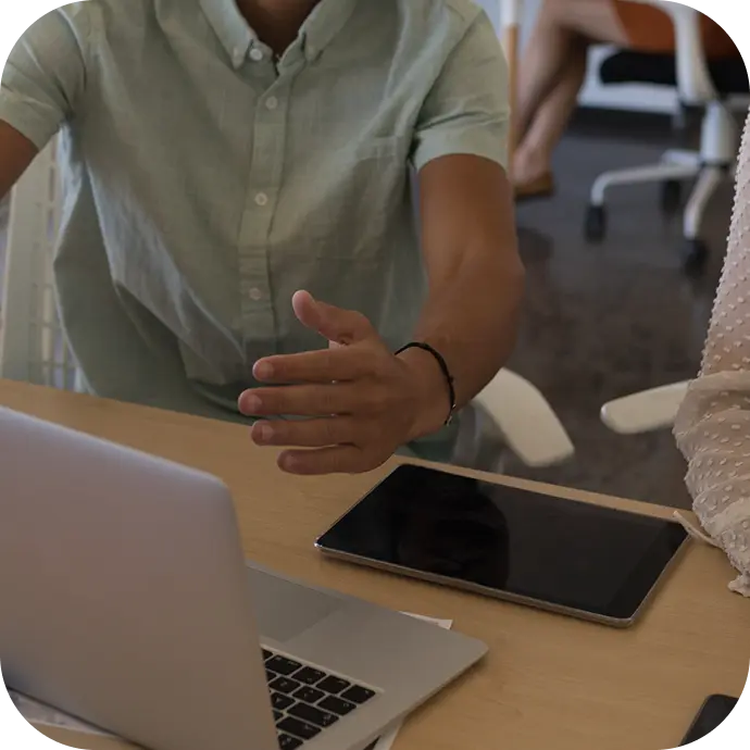 Designers reviewing work together at a workspace table.