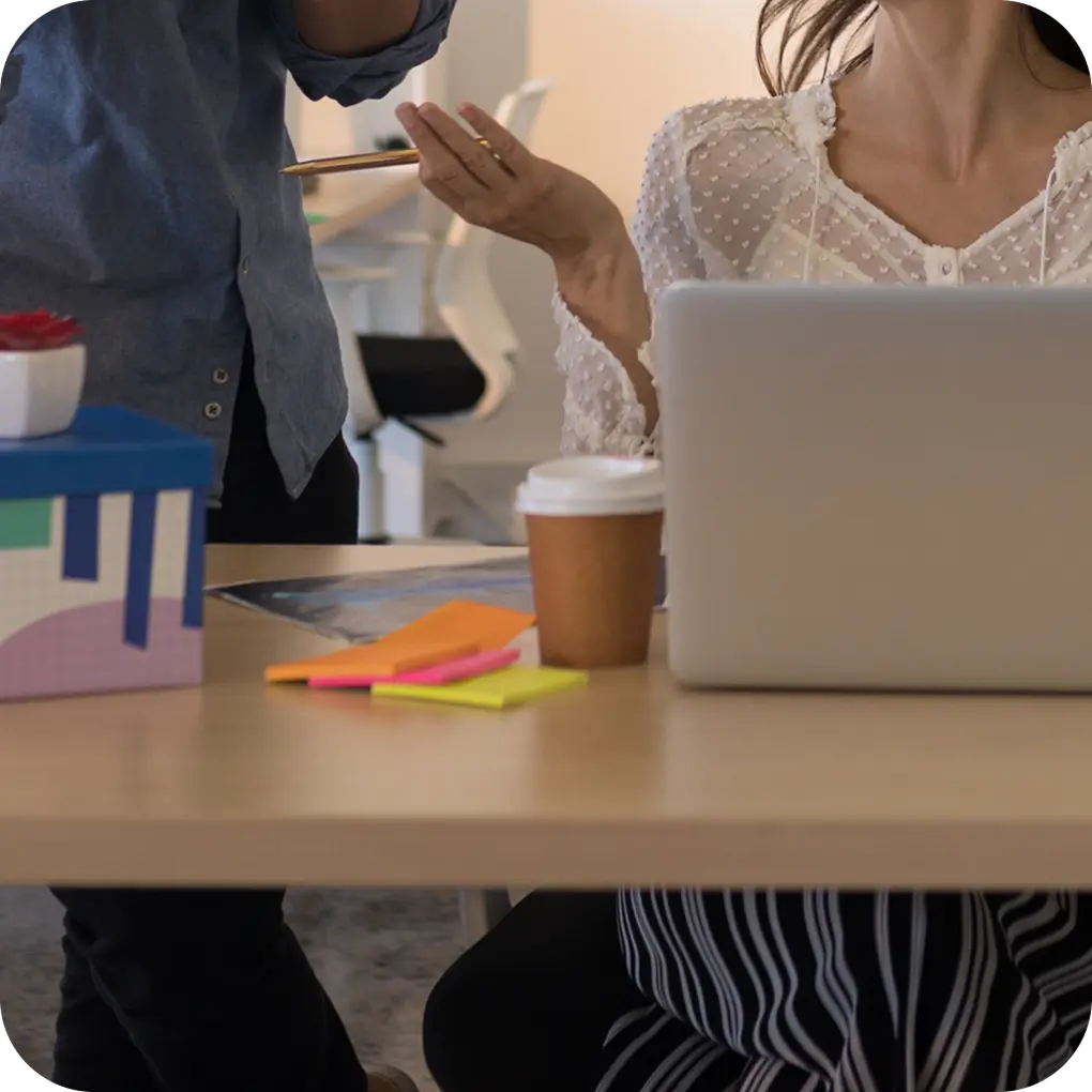 Team members collaborating at a desk with a laptop during the project.