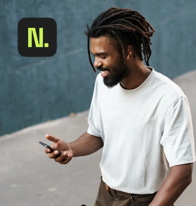 Man outdoors looking at his phone, with the Neobank app icon alongside.