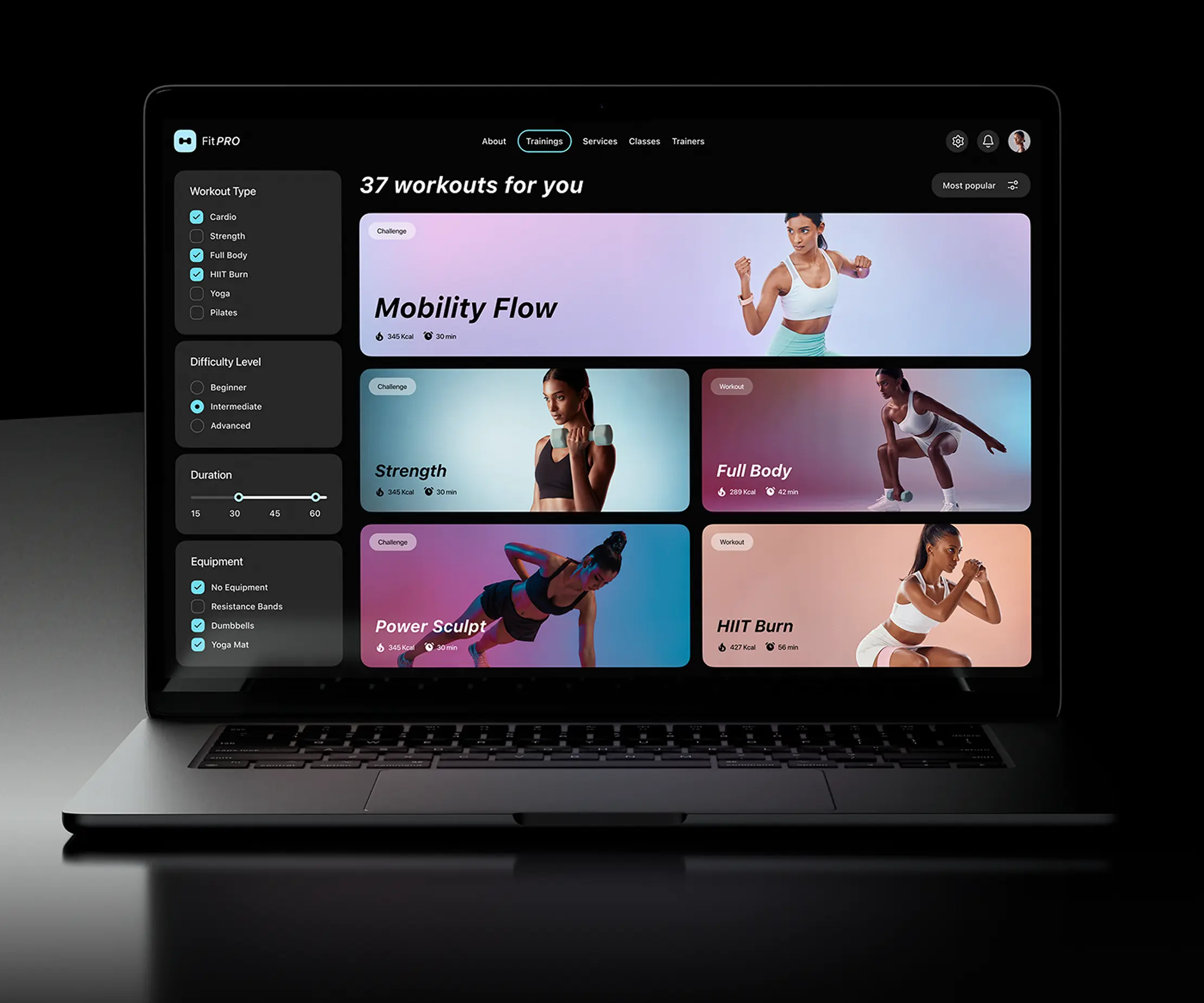 Laptop showing the fitness app workout library with filters and workout cards.