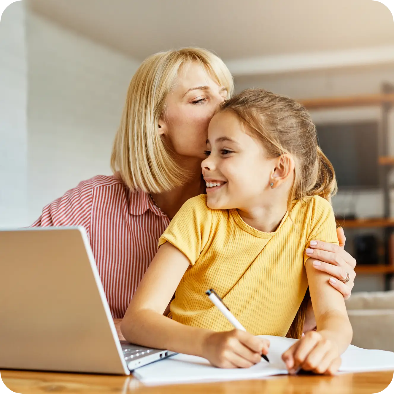 Parent and child learning together at a laptop using the virtual classroom.