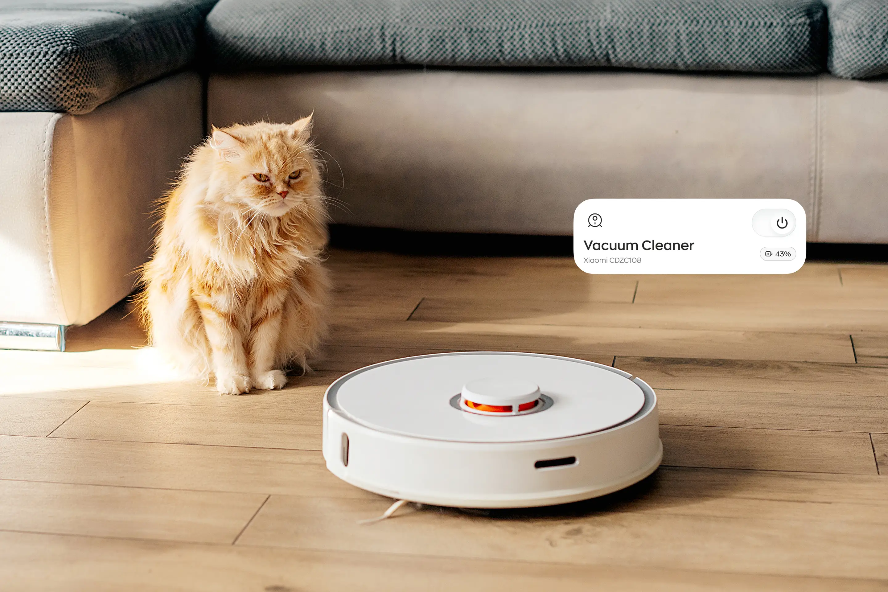 Cat beside a robot vacuum at home with a smart-home app control card overlay.