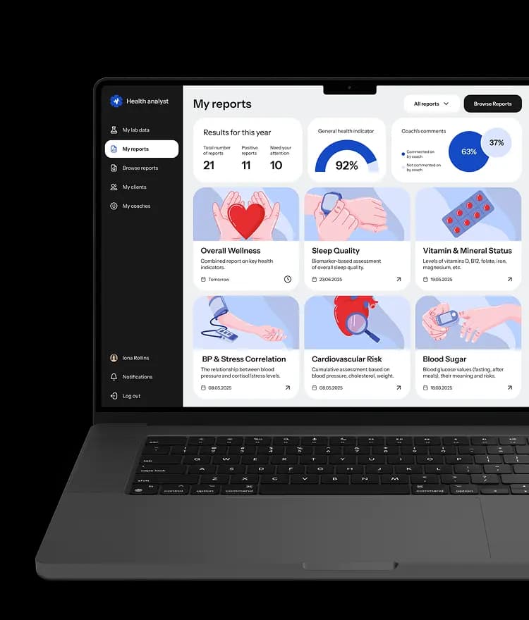 Laptop showing the My reports dashboard in the health platform, with report cards, a health indicator gauge and coach comment stats.